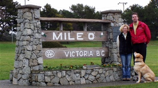 A picture of Martha, Doug and Sam in front of the TransCanada 'Mile 0' sign in Victoria, BC